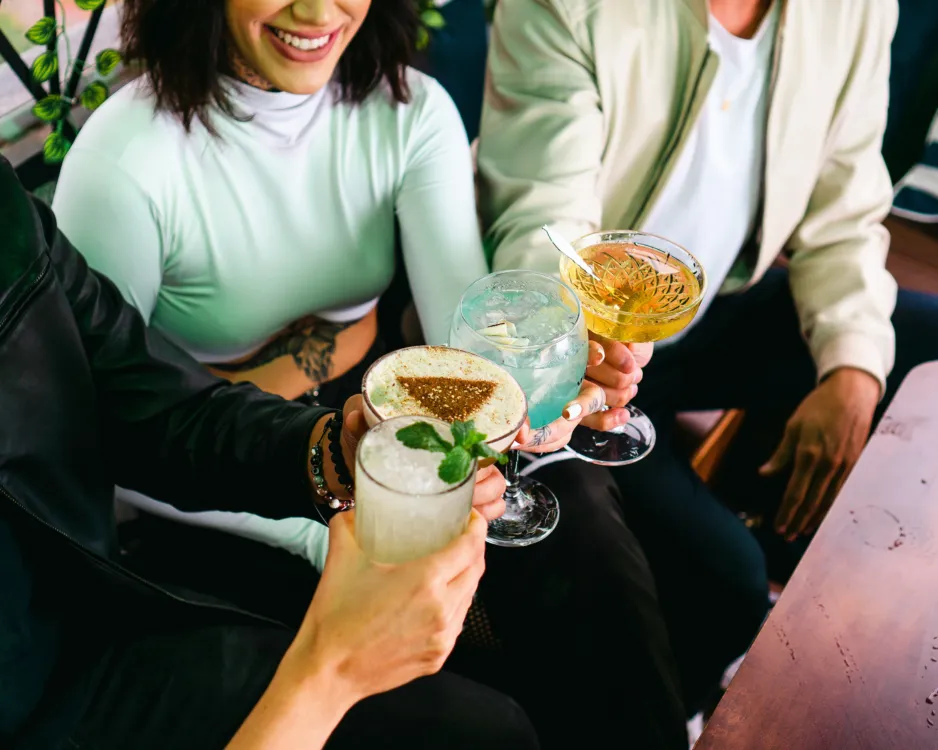 Guests raising crafted cocktails at a corporate event